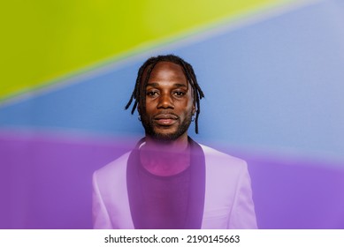 Artistic Portrait With Gel Lights. Handsome Man Posing On Colored Backgrounds