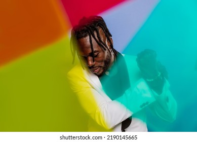 Artistic Portrait With Gel Lights. Handsome Man Posing On Colored Backgrounds