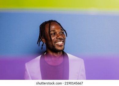 Artistic Portrait With Gel Lights. Handsome Man Posing On Colored Backgrounds