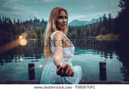 Artistic portrait with lights bulbs on model in a beautiful natural location