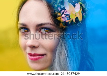 Artistic portrait of a woman in flowers in blue and yellow colors