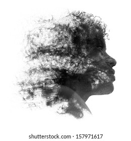 Artistic portrait of a young African woman with fine grains of sand caught in her curly frizzy hair and coating the skin of her face, black and white profile image isolated on white