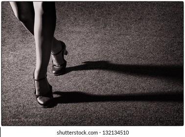 Artistic tap dancer legs dancing tap, legs fragment close up croped version, old style artistic photo in film version