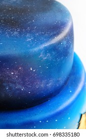 Artistic Two-tiered Cake With The Image Of The Cosmos Drawn By Airbrush. Galaxy, Stars In The Night Sky And Silhouettes Of Trees. Cutout. Picture For A Menu Or A Confectionery Catalog. Close-up.