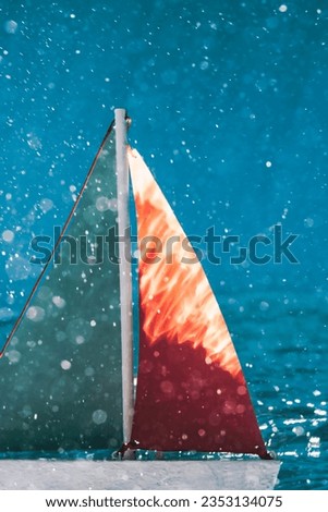 Artistic underwater photograph of miniature boat under the sea surface.