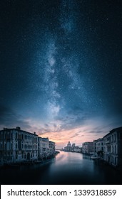 Artistic view of grand canal and Basilica di Santa Maria della Salute in Venice, Italy under majestic milky way