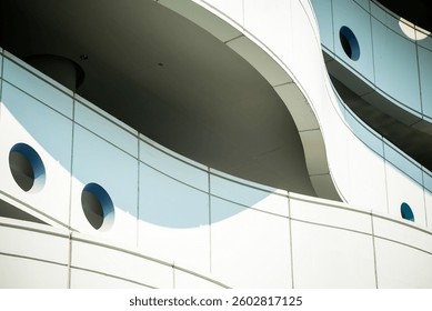 An artistic view of a modern architectural detail showcasing smooth curves, geometric shapes, and contrasting colors. Perfect for design and architecture themes.