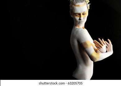 Artistic Woman Painted With  White And Bronze Colors, Over Black Background. Body Painting Project.