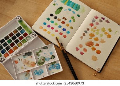 Artistic Workspace with Portable Watercolor Palette and Color Swatch Testing for Creative and Design Inspiration - Powered by Shutterstock