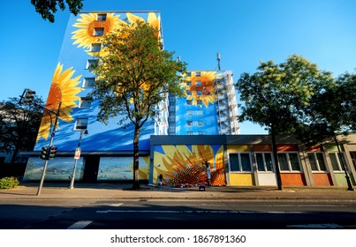 artistically painted house, skyscraper with huge sunflower blossoms on blue house wall, mural painting, in Wuppertal Oberbarmen, Berlinerstrasse