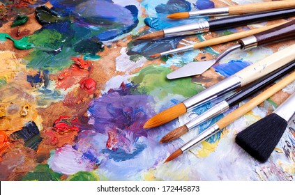 artists brushes and oil paints on wooden palette  - Shutterstock ID 172445873