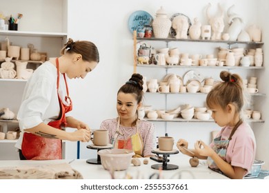 Artists crafting pottery in a creative studio during a sunny afternoon - Powered by Shutterstock