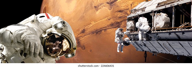 An Artist's Depiction Of  A Team Of Astronauts Performing Work On A Space Station While Orbiting Above The Surface Of Mars. Elements Of This Image Furnished By NASA.