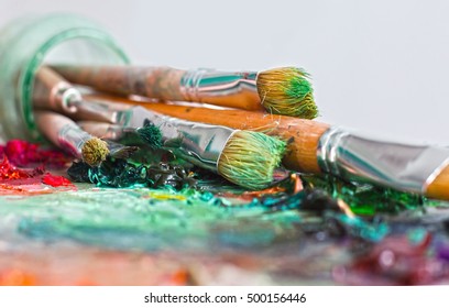 artist's palette with oil paints and brushes used for painting and drawing