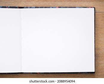 Artists Sketchbook, Sketch Book, Notebook. Empty Plain White Paper Page Open On A Wooden Desk Or Table, Flat Lay