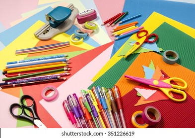 Arts and craft supplies. Corrugated color paper, pencils, different washi tapes, craft scissors.