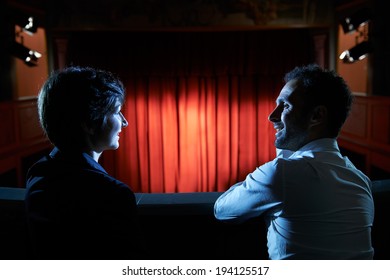 Arts And Entertainment In Theatre, With Man And Woman Looking At Stage With Red Curtains