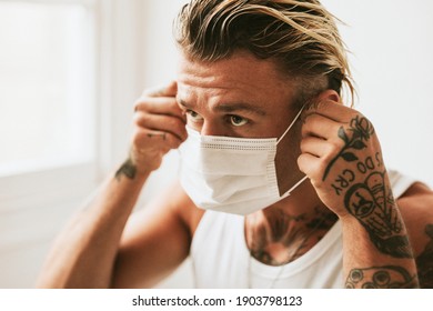 Artsy Man Putting On A Face Mask Due To Pollution