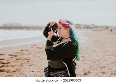 Artsy Woman Taking A Photo At A Beach