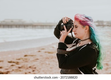 Artsy Woman Taking A Photo At A Beach