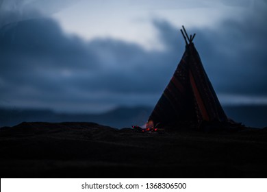 Artwork decoration creative concept. An old native american teepee in desert at the evening. Wigwam house indian style.