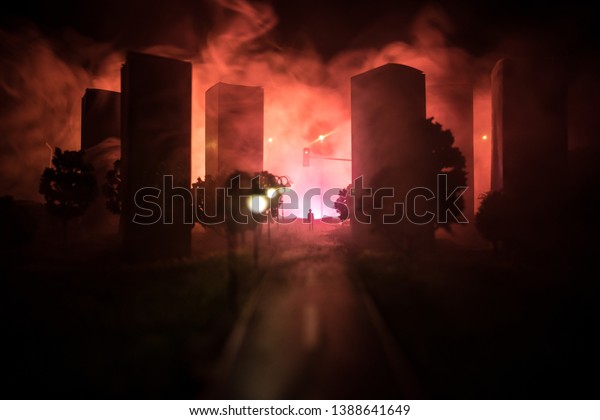 Artwork\
decoration. A man standing on a road of burnt up city. Apocalyptic\
view of city downtown as disaster film poster concept. Night scene.\
City destroyed by war. Selective\
focus