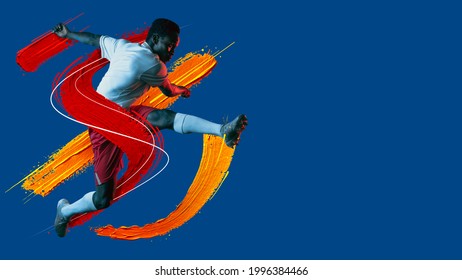 Artwork. Modern design. Young african man, soccer footbal player with ball training in neon light on blue background. Watercolor paints. Concept of sport, game, action. Copyspace for ad. flyer