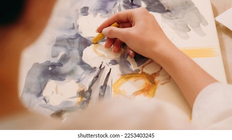 Artwork painting. Visual art. Hobby inspiration. Female artist creating yellow blue color abstract design picture with wax crayon on paper canvas. - Powered by Shutterstock