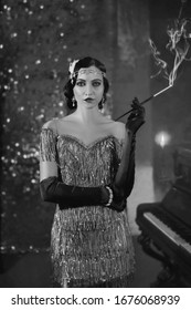 Artwork portrait young flapper retro beautiful woman. mouthpiece in hand cigarette smoke. backdrop shine brilliant bokeh classic room. black and white old photo. wave hairstyle. fashion style 1920s