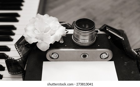 Artwork in retro style, old camera, film, piano, white flower - Powered by Shutterstock