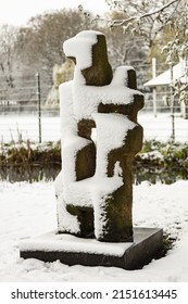 Artwork Sculpture In Public Park In Utrecht Covered In A Thick Layer Of Frost Snow With Greenery Winter Scene In The Background