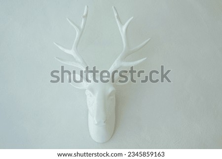 Artwork with white deer head on white background as home decoration.