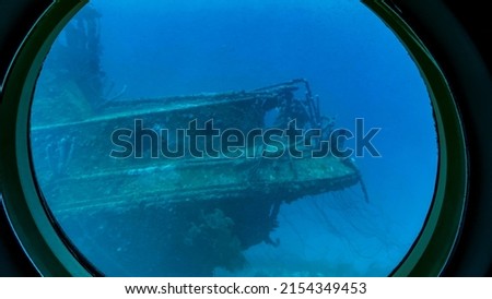 Aruba -2022: View from viewing portals on Atlantis VI Submarine. Canadian passenger submarine company. Interior of the tourist submarine Atlantis whilst submerged. Sunken ship makes coral reef.