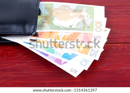 Aruban Florin in the black wallet 
