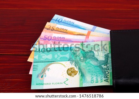 Aruban Florin in the black wallet 
