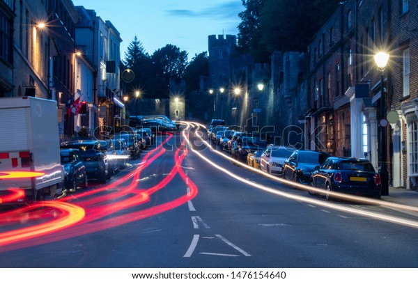 Arundel High Street, England, night photo with\
car light trails. Arundel is a popular tourist attraction with a\
beautiful castle and impressive\
cathedral.