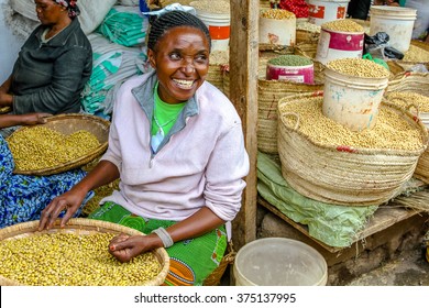 Arusha, Tanzania, Africa - January 2, 2013: Happy Woman Selling Cereals At Town Market