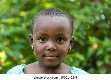 Arusha, Tanzania - december 24, 2019 : Unknown african young happy girl on a street in Arusha, Tanzania, East Africa, close up