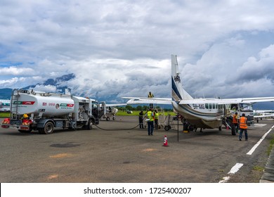 Arusha, Tanzania - December 28, 2019 : Fuel Truck Refueling Small Propeller Airplane Before Takeoff At Arusha Airport, Tanzania, East Africa