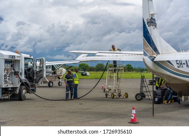 Arusha, Tanzania - december 28, 2019 : Fuel truck refueling small propeller airplane before takeoff at Arusha airport, Tanzania, east Africa
