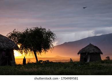 Arusha, Tanzania On 1st June 2019. Family With Masai Walking At Sunrise At There House.