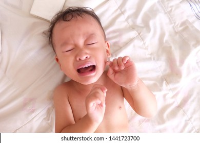 Asain Baby Boy Sleep On White Mattress And Crying