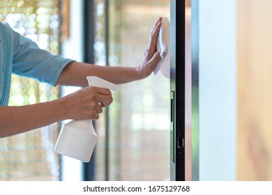 Asain Maid Worker Is Cleaning The Mirror Door In Front Of Meeting Room To Protect Coronavirus Before Event Start.