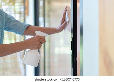 Asain Maid Worker Is Cleaning The Mirror Door In Front Of Meeting Room To Protect Coronavirus Before Event Start.