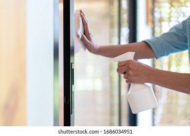 Asain Maid Worker Is Cleaning The Mirror Door In Front Of Meeting Room To Protect Coronavirus Before Event Start.