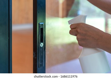 Asain Maid Worker Is Cleaning The Mirror Door In Front Of Meeting Room To Protect Coronavirus Before Event Start.