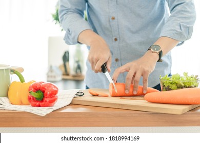 Asain Man Cooking In The Home Kitchen.