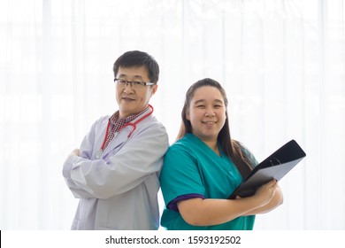 Asain Man Doctor And Woman Nurse Teamwork Fold Over Smile With White Curtain Background