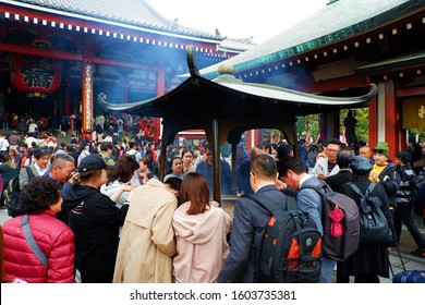 Asakusa, Tokyo, Japan - November 24, 2019: A busy Sunday morning for locals and tourists praying for peace and guidance at the Sensō-ji Temple.