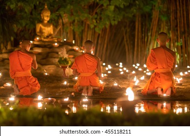 Asalha Puja Day ,Monks light candles and pray to buddha statue in Phan tao temple , Chiang mai ,Thailand.